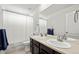 Bright bathroom features dual sinks, a large mirror, and a shower with a bathtub at 24784 E Tennessee Pl, Aurora, CO 80018