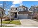 Charming two-story home with a well-manicured lawn and attached two car garage at 24784 E Tennessee Pl, Aurora, CO 80018