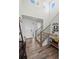 Bright foyer with hardwood floors, staircase, and modern chandelier, creating a grand entry at 24784 E Tennessee Pl, Aurora, CO 80018