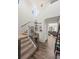 Bright foyer with hardwood floors, staircase, and modern chandelier, creating a grand entry at 24784 E Tennessee Pl, Aurora, CO 80018