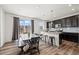 Bright dining area and modern kitchen with sleek countertops and island seating at 24784 E Tennessee Pl, Aurora, CO 80018