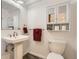 Cozy bathroom featuring a stylish vanity, toilet, and mirrored wall cabinet at 2700 W Greens Pl, Littleton, CO 80123