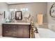 Modern bathroom features a dual vanity, soaking tub, and stylish fixtures at 2700 W Greens Pl, Littleton, CO 80123