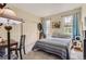 Cozy bedroom with a warm ambiance, featuring soft carpet, a bed, and closet doors at 2700 W Greens Pl, Littleton, CO 80123