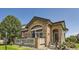 Charming home featuring a stone facade and inviting front porch with decorative accents and well-manicured landscaping at 2700 W Greens Pl, Littleton, CO 80123