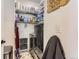 Efficient laundry room equipped with modern appliances and shelving for ample storage space at 2700 W Greens Pl, Littleton, CO 80123