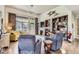Inviting living room with a fireplace, bookshelves, and comfortable armchairs, perfect for relaxation at 2700 W Greens Pl, Littleton, CO 80123