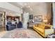 Cozy living room features a plush yellow sofa and unique decor, creating an inviting space at 2700 W Greens Pl, Littleton, CO 80123