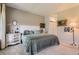 Comfortable main bedroom featuring soft carpet, a decorative headboard, and soothing neutral paint at 2700 W Greens Pl, Littleton, CO 80123