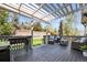 Back deck with outdoor grill, patio furniture and pergola providing shade at 3928 Miners Candle Dr, Castle Rock, CO 80109