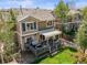 Aerial view of home exterior, with large deck and manicured backyard at 3928 Miners Candle Dr, Castle Rock, CO 80109