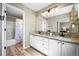 Bathroom with double sink, granite countertops, and a shower/tub combo at 3928 Miners Candle Dr, Castle Rock, CO 80109