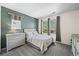 Comfortable bedroom features soft carpet, natural light and serene blue accent wall at 3928 Miners Candle Dr, Castle Rock, CO 80109