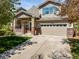 Front exterior view of a charming home with a well-maintained lawn, porch, and two-car garage at 3928 Miners Candle Dr, Castle Rock, CO 80109