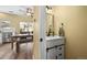 A lovely powder room with a cabinet sink and views of the dining room at 3928 Miners Candle Dr, Castle Rock, CO 80109