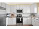 Bright kitchen with white cabinets, stainless steel appliances, and subway tile backsplash at 3928 Miners Candle Dr, Castle Rock, CO 80109