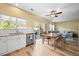 Bright kitchen view with white cabinets and countertops; includes dining table and outdoor access at 3928 Miners Candle Dr, Castle Rock, CO 80109