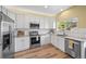 Well-lit kitchen featuring white cabinets, stainless steel appliances, and granite countertops at 3928 Miners Candle Dr, Castle Rock, CO 80109