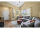 Bright and inviting living room featuring vaulted ceilings, a large sectional, and hardwood floors at 3928 Miners Candle Dr, Castle Rock, CO 80109