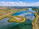 Stunning aerial view of community lake surrounded by picturesque landscape at 12846 Palisade St, Mead, CO 80504