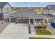 Beautiful aerial view of this single-story home with a well-manicured lawn, three-car garage, and inviting front porch at 12846 Palisade St, Mead, CO 80504