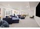 Spacious finished basement with a large sectional sofa, game area, and modern decor at 12846 Palisade St, Mead, CO 80504