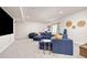 Finished basement space with gray carpet, a comfortable sectional sofa, and natural light at 12846 Palisade St, Mead, CO 80504