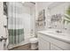 Clean bathroom with a shower-tub combo, white subway tile, and modern fixtures, and shelving at 12846 Palisade St, Mead, CO 80504