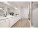 Bright bathroom features double sinks, white cabinets, quartz counters, and a large glass shower at 12846 Palisade St, Mead, CO 80504