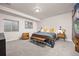 Comfortable bedroom featuring a bed, nightstand, and a cozy chair near a window at 12846 Palisade St, Mead, CO 80504
