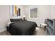 Cozy bedroom with neutral decor, hardwood floors, and ample natural light from the window at 12846 Palisade St, Mead, CO 80504