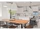 Open dining area featuring a rustic wooden table, modern chairs, and adjacent gourmet kitchen at 12846 Palisade St, Mead, CO 80504