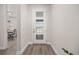 Bright foyer features wood-look flooring and a modern front door with glass panels at 12846 Palisade St, Mead, CO 80504