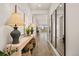 Spacious hallway with wood floors, offering a view through the house, and decorative mirrors on the wall at 12846 Palisade St, Mead, CO 80504