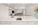 Open concept kitchen with an island, sink, quartz countertops, and views into the finished basement at 12846 Palisade St, Mead, CO 80504