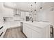 Bright kitchen featuring stainless steel appliances, white cabinetry, quartz countertops, and pendant lighting at 12846 Palisade St, Mead, CO 80504