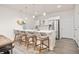 Bright kitchen with a large island, modern barstools, stainless steel appliances, and wood accents at 12846 Palisade St, Mead, CO 80504