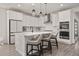 Bright kitchen featuring white cabinets, quartz countertops, stainless steel appliances, and a center island with seating at 12846 Palisade St, Mead, CO 80504