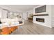 Inviting living room with modern fireplace, comfortable seating, and seamless flow to the kitchen and dining area at 12846 Palisade St, Mead, CO 80504