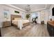 Serene bedroom with tray ceilings, large windows, modern light fixtures, and a cozy atmosphere at 12846 Palisade St, Mead, CO 80504