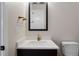 Powder bath featuring a modern vanity with a black framed mirror at 8015 Parnassus Pl, Castle Rock, CO 80108