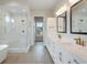 Elegant bathroom with dual sinks, quartz countertops, soaking tub and glass-enclosed shower at 8015 Parnassus Pl, Castle Rock, CO 80108