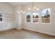 Bright dining room with built-in cabinetry, modern light fixture, and large windows at 8015 Parnassus Pl, Castle Rock, CO 80108