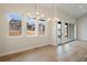 Inviting dining area with hardwood floors, stylish chandelier, and scenic neighborhood views at 8015 Parnassus Pl, Castle Rock, CO 80108