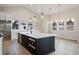 Modern kitchen featuring stainless steel appliances, a large island, and stylish pendant lighting at 8015 Parnassus Pl, Castle Rock, CO 80108