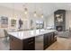Open kitchen featuring an island with a sink, stainless steel appliances, and views of the living room at 8015 Parnassus Pl, Castle Rock, CO 80108