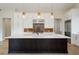 Stunning kitchen features an oversized island, modern appliances, and pendant lighting at 8015 Parnassus Pl, Castle Rock, CO 80108