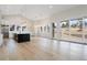 Spacious living room with vaulted ceilings and access to the backyard through sliding glass doors at 8015 Parnassus Pl, Castle Rock, CO 80108