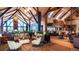 A luxurious lobby with high ceilings, sofas, lounge chairs and plants at 8015 Parnassus Pl, Castle Rock, CO 80108