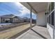 View of the backyard area with stone and grass, with covered patio perfect for relaxing at 8926 S Rome Ct, Aurora, CO 80016
